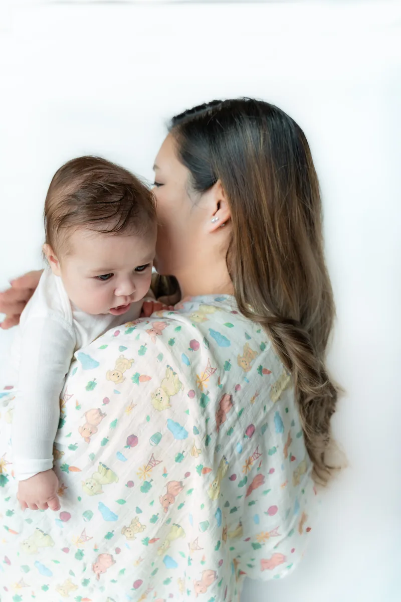Parent holding baby with blanket
