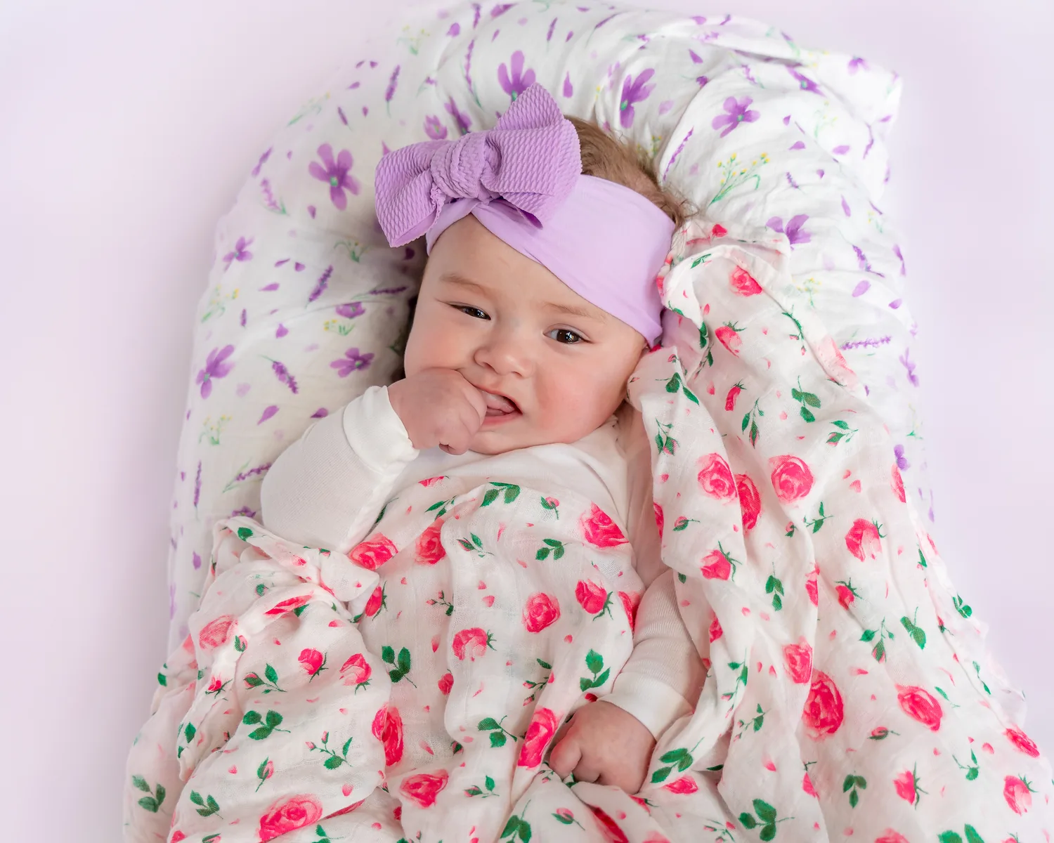 Baby wrapped in floral blanket